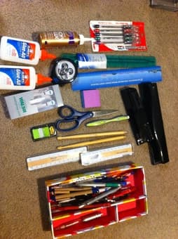 lots of pens, 3-hole punch, glue, rulers, earbuds, scissors 1