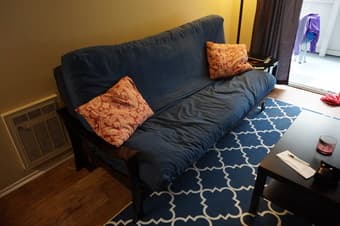 Black wooden futon with mattresses and covers $125 2