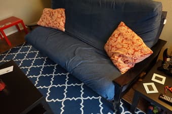 Black wooden futon with mattresses and covers $125 3