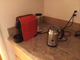 FOR SALE: Nespresso coffee machine, a milk foamer and assorted capsules 1