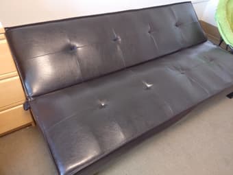 Black leather futon, less than a year old! 2