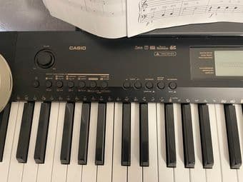 Casio Piano with seat, paddle, and headphone 3
