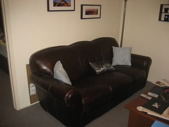 Dark chocolate brown leather sofa ($400) 1