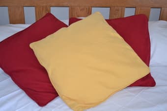 2 Red and 1 Yellow IKEA cushions and covers 1