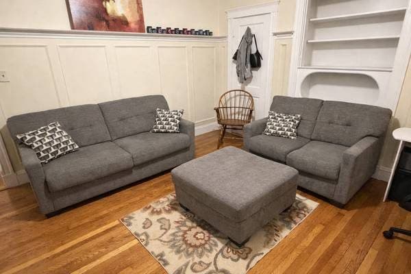 Grey sofa, loveseat, and oversized ottoman + four decorative pillows 1