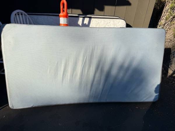 Twin-size foam mattress with zippered cover. 1